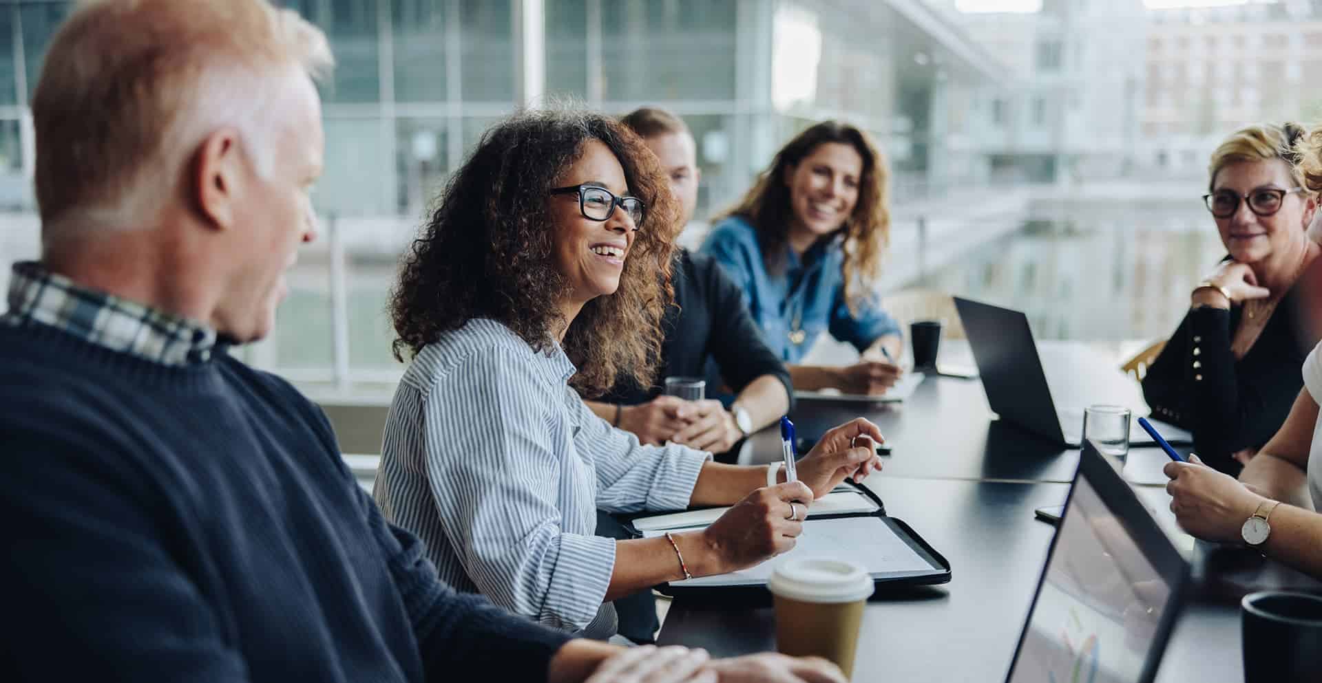 A group smiling during a business meeting