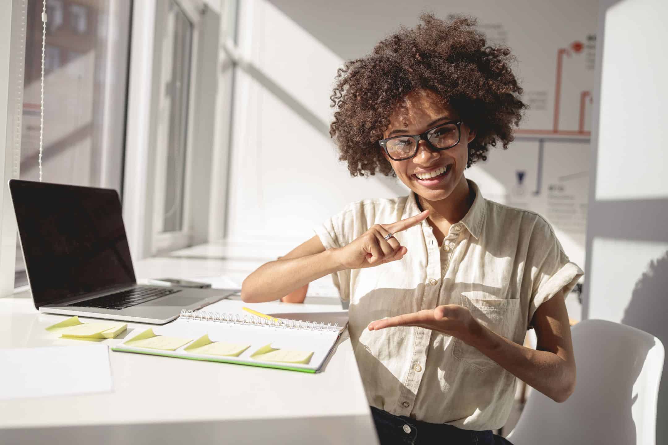 lady sitting at desk doing sign language