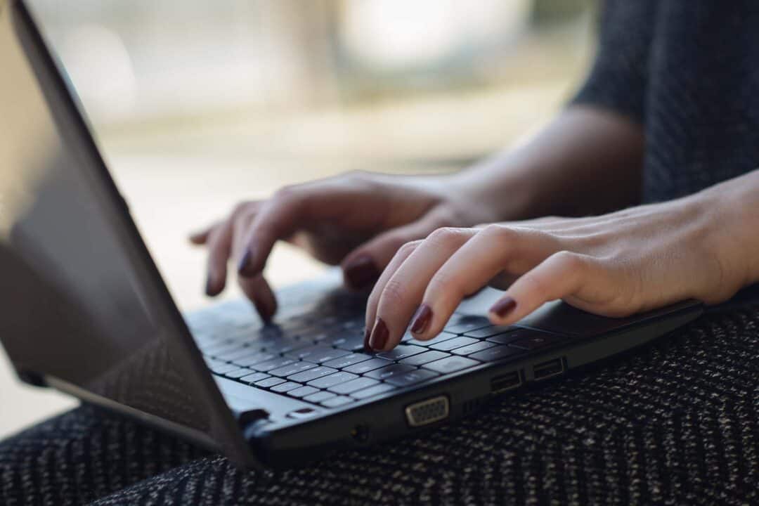 A woman typing on a laptop