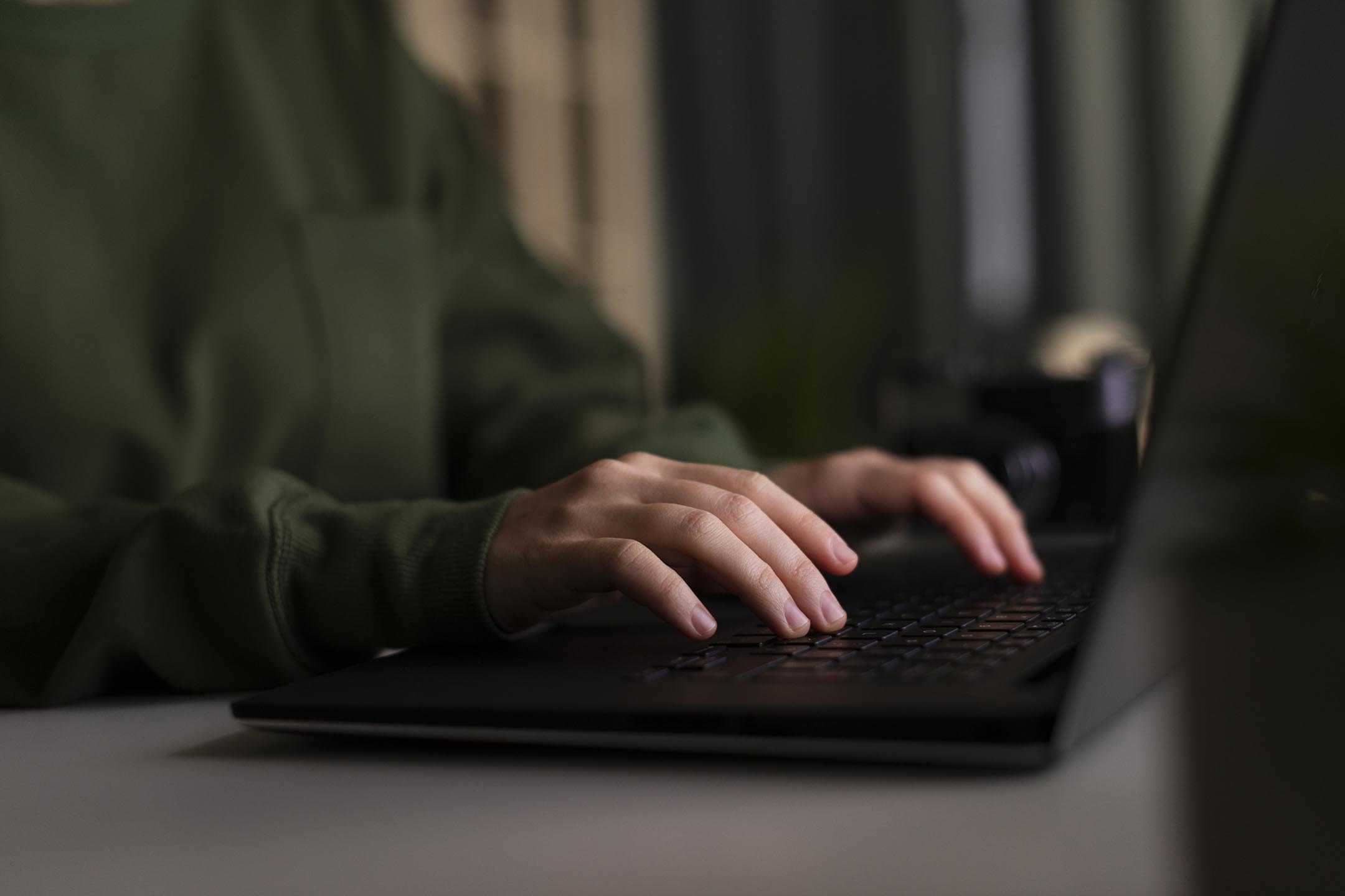 A woman typing on her laptop