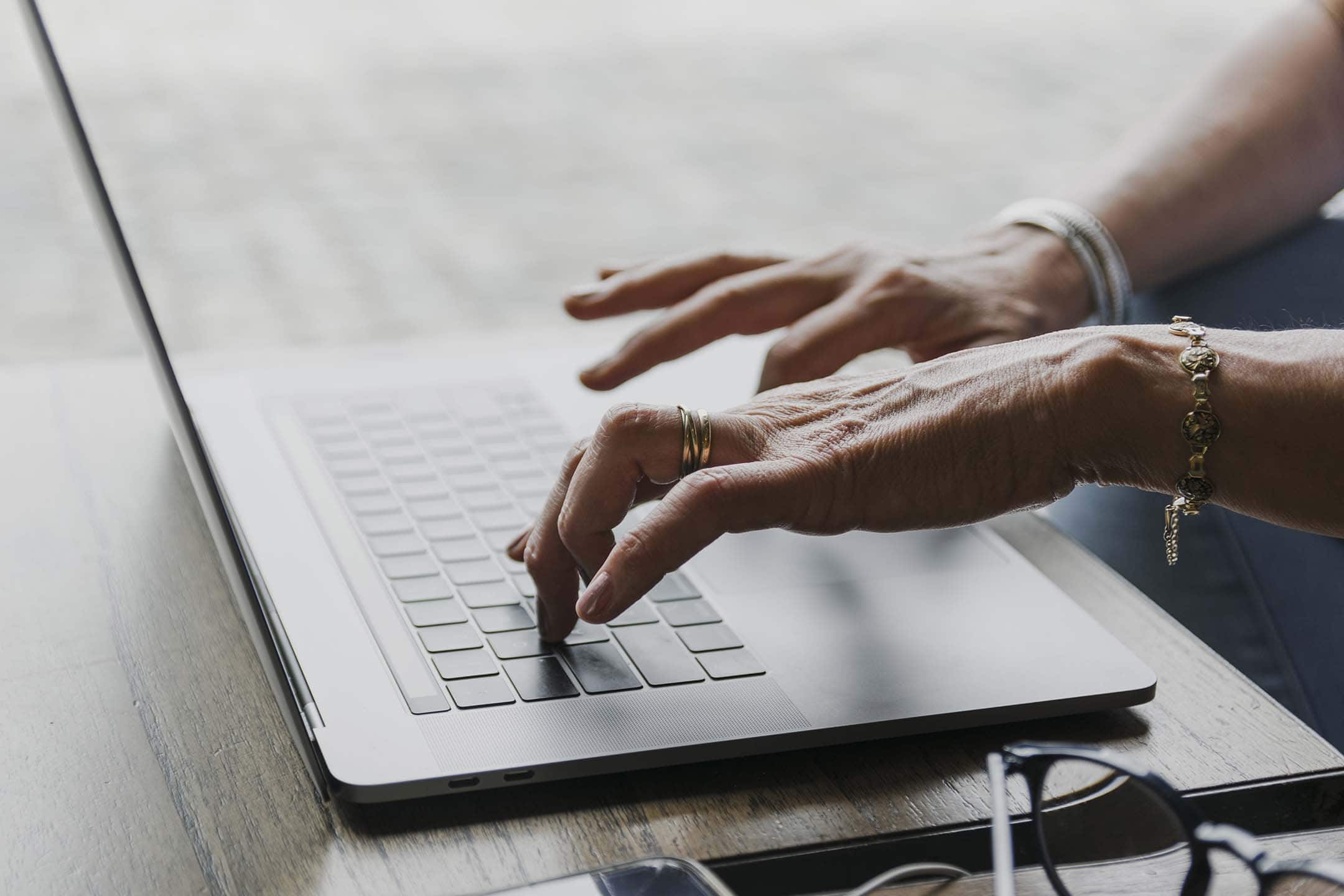 A woman typing on a laptop